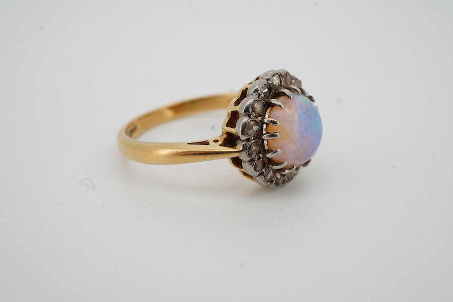 An early 20th century 18ct, opal and rose cut diamond set circular cluster ring, size N/O, gross weight 4.3 grams.